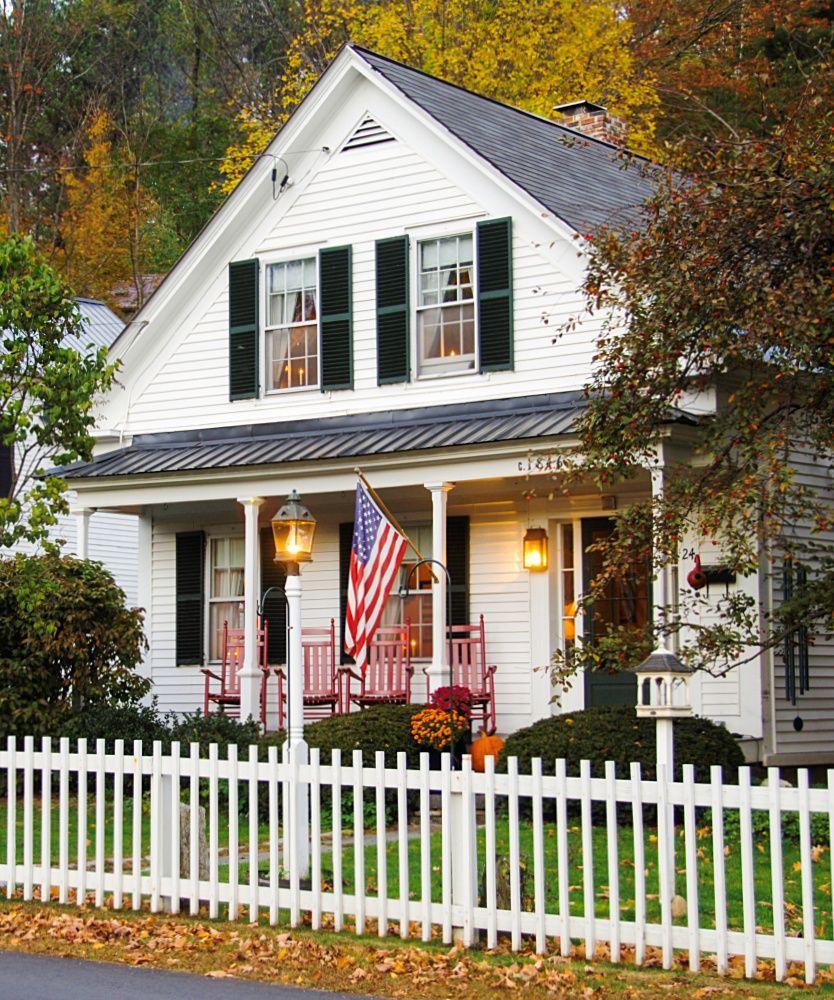 American home with a front porch and flag
